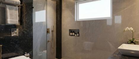 A modern bathroom with a glass-enclosed shower, a toilet, a sink, and a window providing natural light.