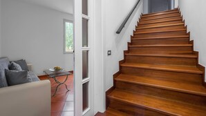 A wooden staircase with a handrail, a white wall, and a door leading to another room. - Borgo House In Florentine Hills With Pool (Fucecchio)