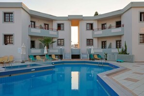 Seasonal outdoor pool, open 9:00 AM to 7:00 PM, pool umbrellas