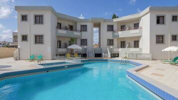 Seasonal outdoor pool, open 9:00 AM to 7:00 PM, pool umbrellas