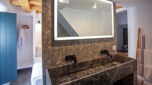 A bathroom with a large mirror, two sinks, and a towel rack. - The pelican heritage house, Rooftop Chora Mykonos center (mykonos)