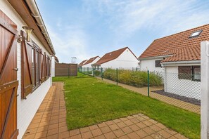 Stroll through the well-manicured lawn to the simple, functional building with a red-tiled roof.