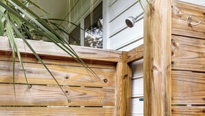 A wooden gate with a metal handle and a latch, part of a wooden fence. - Charming Folly Beach Home - Perfect Location (Folly Beach)
