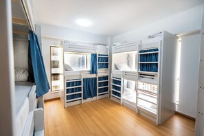A room with bunk beds, a wardrobe, and a window with curtains. - YouSleep Hostel (Dubai)