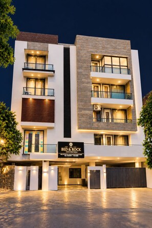 A multi-story hotel with a modern design, featuring balconies and a prominent entrance. - The Bed and Rock (New Delhi)
