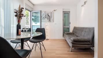 Family Apartment, Balcony, Sea View | Living area | 98-cm TV with satellite channels