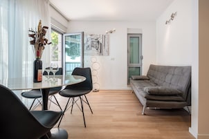Family Apartment, Balcony, Sea View | Living area | 98-cm TV with satellite channels