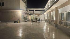 A spacious outdoor area with a concrete floor, multiple seating arrangements, and potted plants. - RIVER HOTEL NAMWON (Namwon)