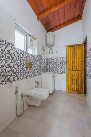 Une salle de bain avec des toilettes, un lavabo et une douche.