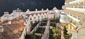 A hotel with multiple white buildings, terracotta roofs, and a central courtyard with pathways and trees. - ZEM Wellness Clinic Altea - 5 Stars Grand Luxury (Altea)
