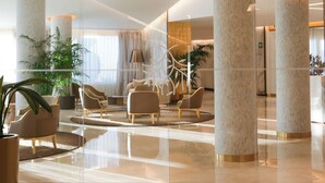 A modern lobby with large columns, comfortable seating, and potted plants. - ZEM Wellness Clinic Altea - 5 Stars Grand Luxury (Altea)