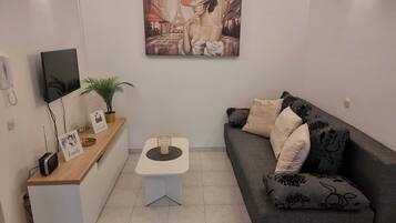 Apartment (One Bedroom Apartment with Balcony an) | Living room | 32-inch flat-screen TV with cable channels