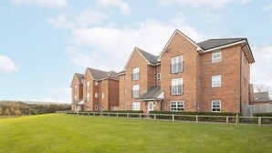 A multi-story residential building with a brick facade, multiple windows, and a flat roof. - Host Stay The Sanctuary (Whitby)