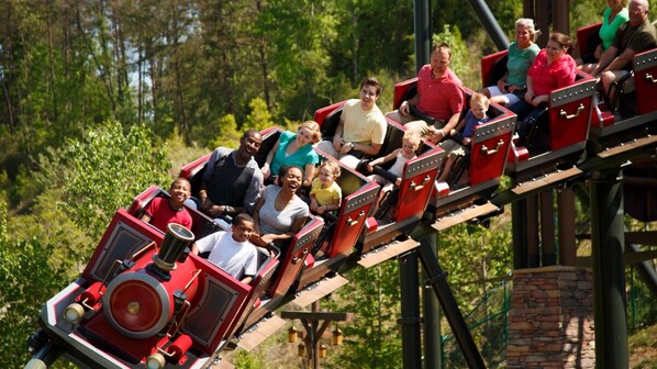 A group of people on a red and black roller coaster. - New Listing! Hot Tub, Foosball, Fireplace, Pool Table, & Free Attractions! (Sevierville)