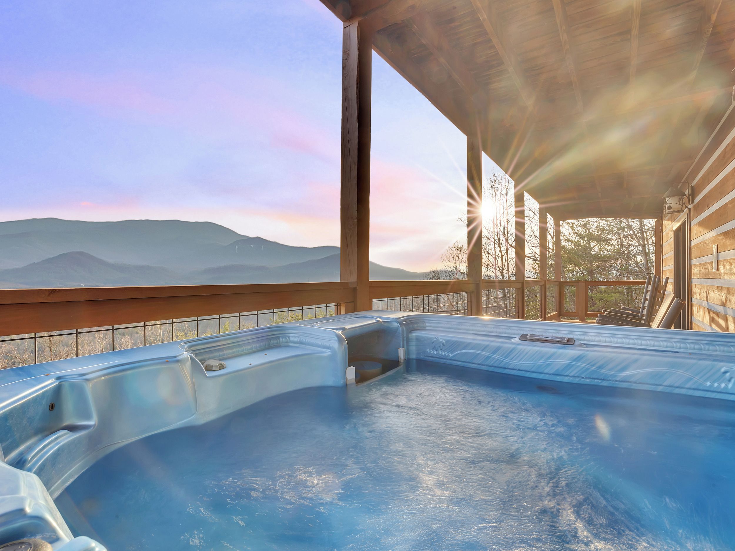 A hot tub with a view of mountains.