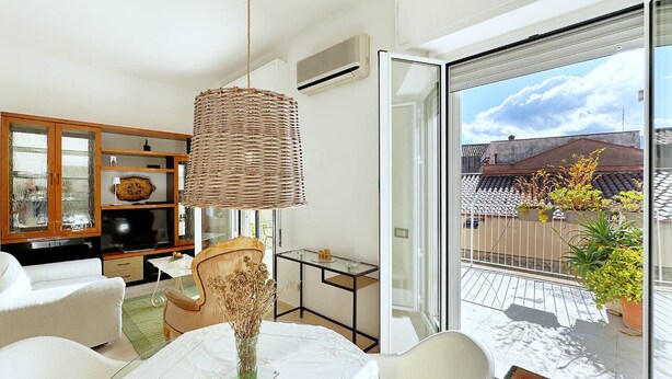 A modern living room with a dining table, chairs, a wicker lamp, and a view of the outside. - Solemar Sicilia - Terrazza del Merlo (Palermo)