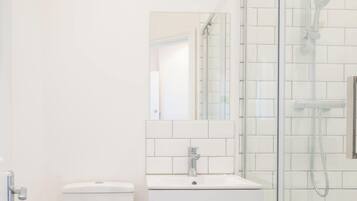 Shower, hair dryer, towels, shampoo