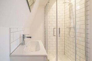 Shower, hair dryer, towels, shampoo