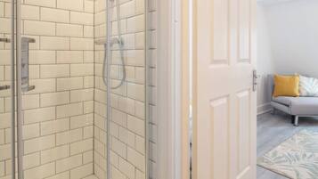 Shower, hair dryer, towels, shampoo