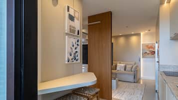 A modern interior with a wooden door, a bench, and a sofa in a well-lit hallway.