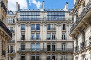 Classic building with a symmetrical facade and grid-patterned windows.