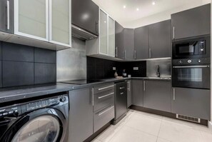Enjoy cooking in this well-equipped kitchen with microwave and oven, plus a convenient water dispenser.