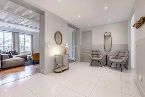 Relax in this stylish living area with a sofa, armchairs, and a side table.