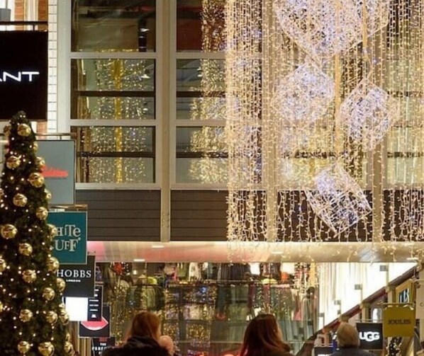 A shopping mall interior with a Christmas tree and illuminated decorations. - Peace house suite

 (Waterlooville)