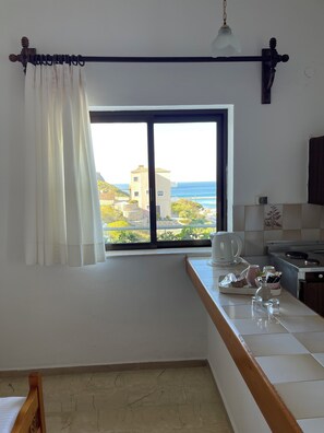 Double Room, Sea View | Private kitchen | Stovetop, electric kettle, cookware/dishes/utensils, cleaning supplies - Aeolos Apartments (Platanias)
