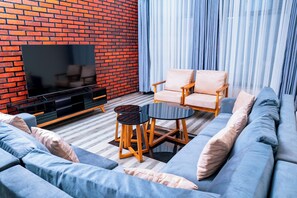 Comfort Apartment, 2 Bedrooms, Smoking, City View | Living area | 65-inch Smart TV with digital channels - Kadoo Travels (Kigali)