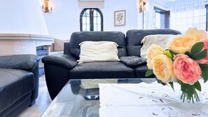 Relax in this stylish living room with a comfortable sofa, coffee table, and armchair.