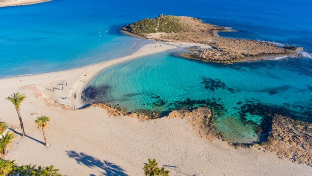 A coastal beach with clear turquoise waters, sandy shores, and rocky outcrops. - Villa Livia in Paralimni (Paralimni)
