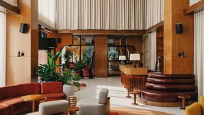 A spacious lobby with a high ceiling, wooden architecture, and a central seating area with sofas and armchairs. - The Standard Brussels (Brussels)