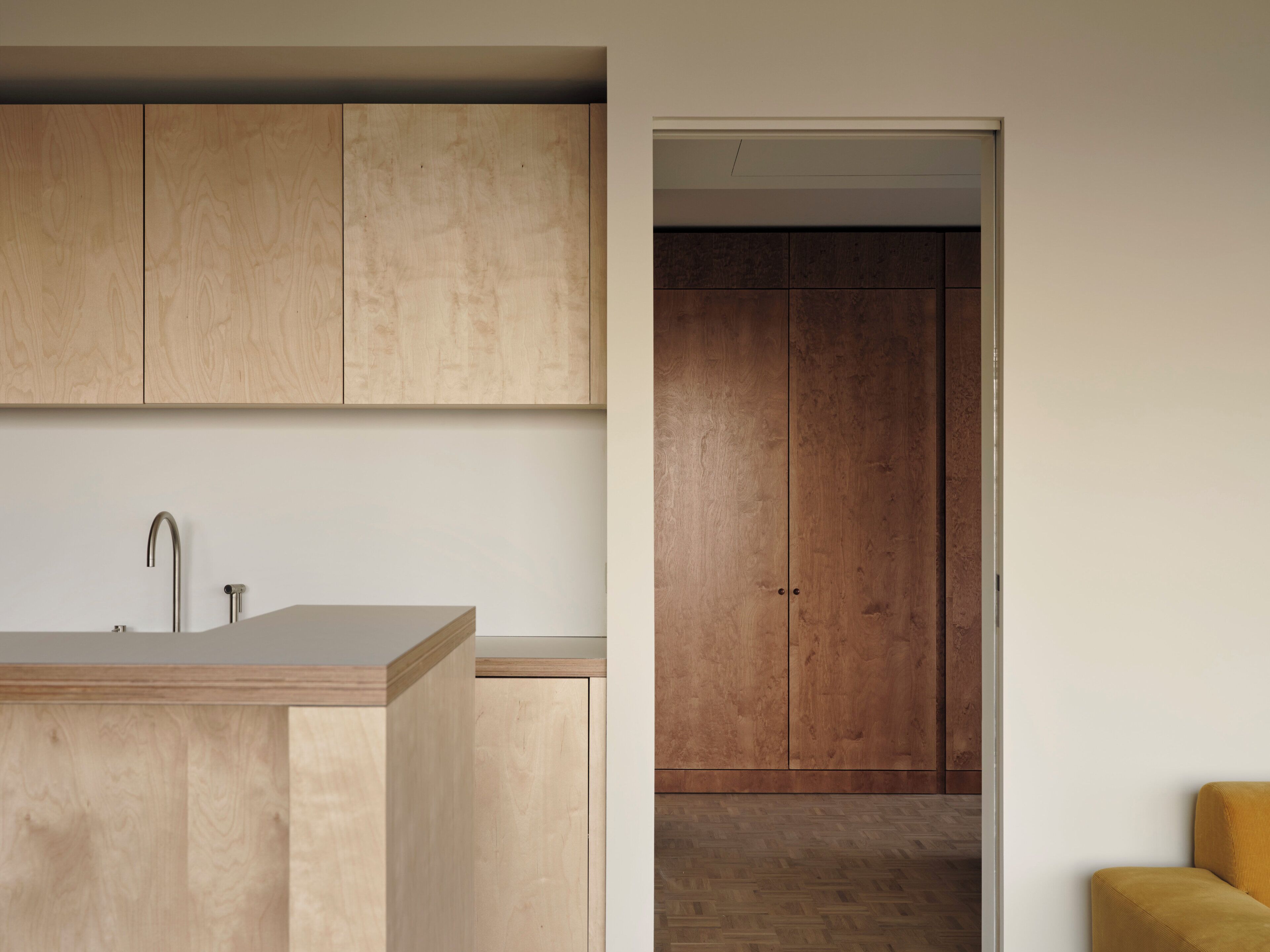 A modern kitchen with wooden cabinets and a sink.