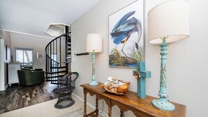 A staircase with a black railing leading to a landing. - Bayside 3 bedroom Bungalow (Gulf Shores)