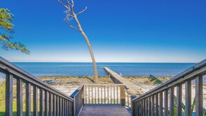 A wooden staircase leading to a beach with a clear view of the ocean. - Bayside 3 bedroom Bungalow (Gulf Shores)