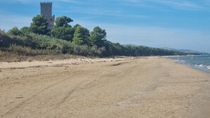 A beach with a tower and dense trees in the background. - Newly renovated apartment,  ideal for relaxing, nature lovers and walkers  

 (Abruzzo)