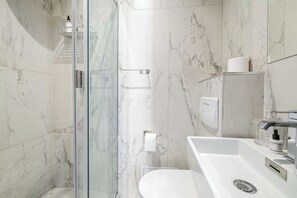 Shower, hair dryer, towels, shampoo