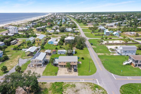 A residential area with houses, roads, and a beach in the background. - Off The Hook (Port St. Joe)
