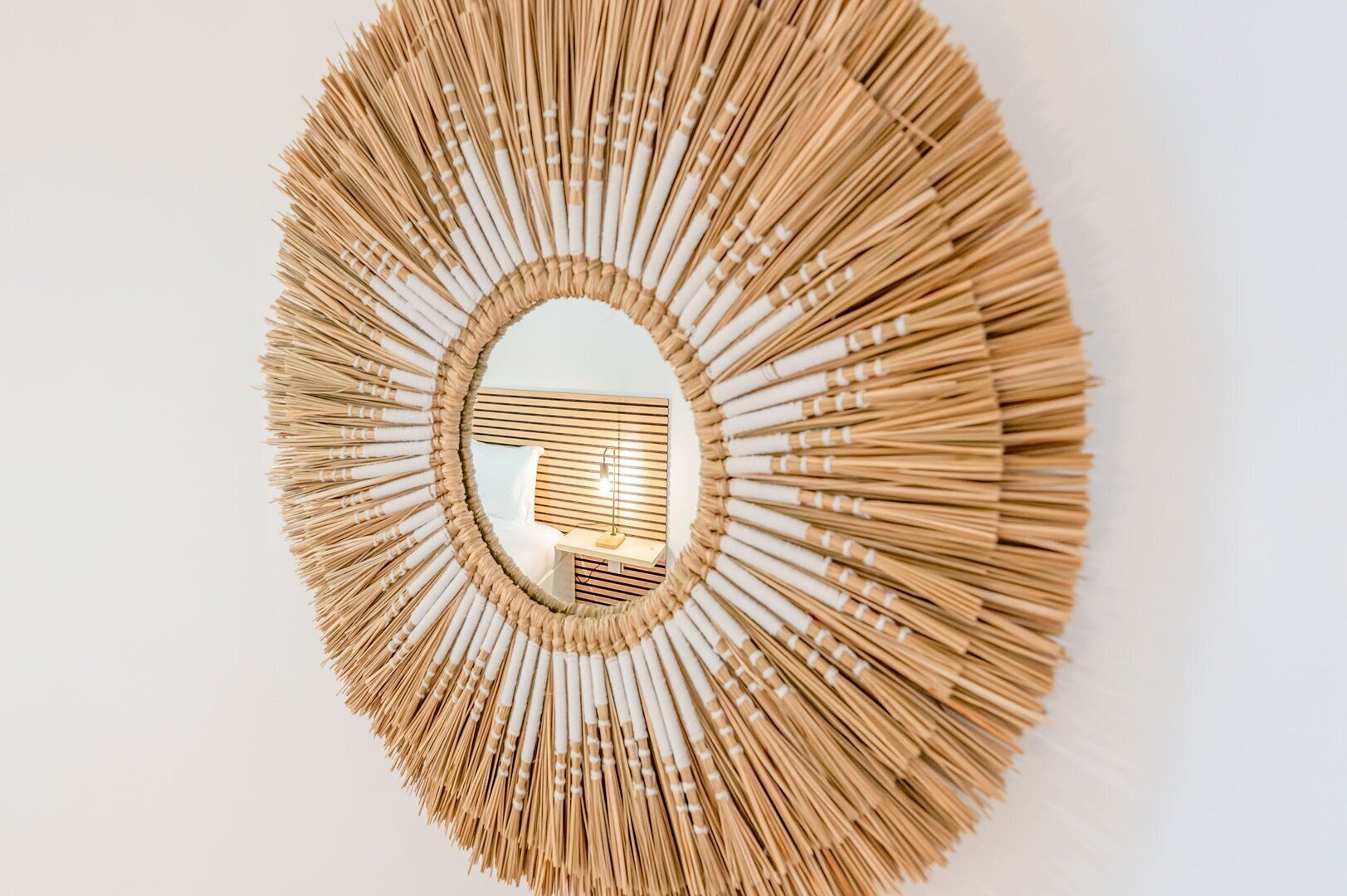 A circular mirror with a wooden frame.