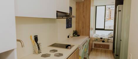 Fridge, microwave, coffee/tea maker, cookware/dishes/utensils