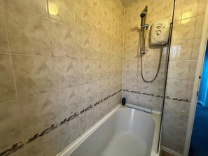 A bathroom with a bathtub, a shower, and a toilet. - 3 Bedroom Home in Telford (Newdale)
