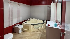 A modern bathroom with a freestanding bathtub, a toilet, and a vanity with a mirror. - CT 355 AL - Faro's Pechina Rural (Pechina)