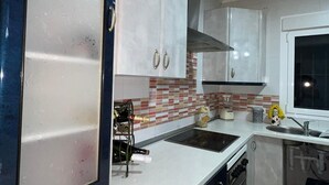 A kitchen with white cabinets, a tiled backsplash, and a window. - CT 355 AL - Faro's Pechina Rural (Pechina)