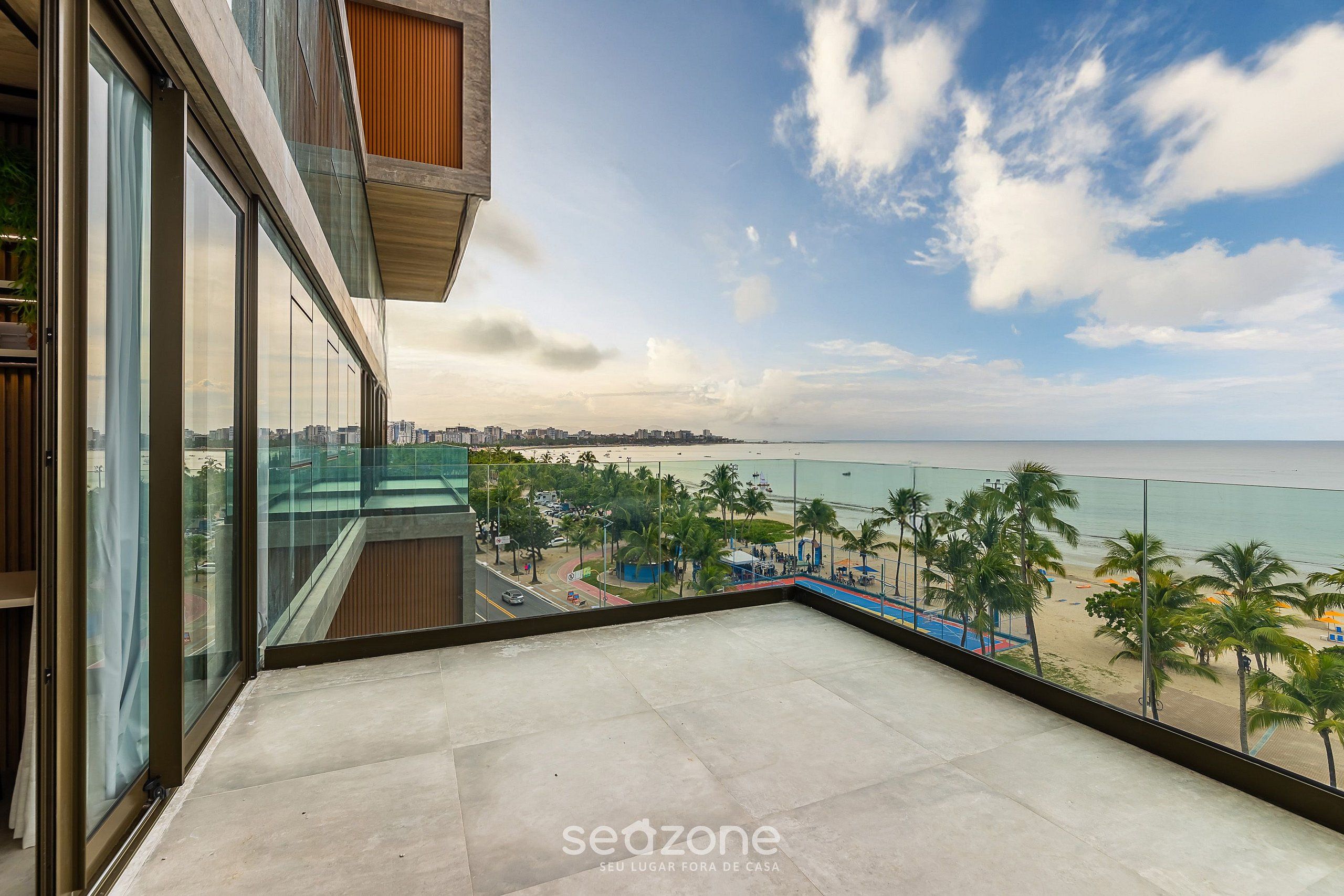 Un balcón con vistas a la playa y al paisaje urbano.