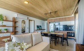 A modern kitchen with wooden cabinets, a microwave, and a stainless steel refrigerator. - NWTs - Apartamentos com Vista Frente-Mar (Maceió)