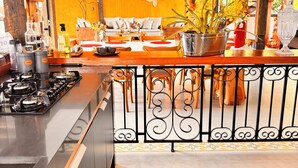 A kitchen with a gas stove, wooden counter, and a decorative backsplash.