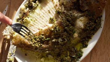 A plate of food with a fork and a knife.