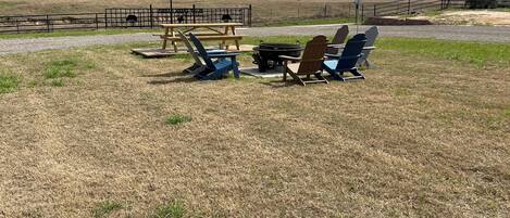 A picnic area with a flag, chairs, and a table.