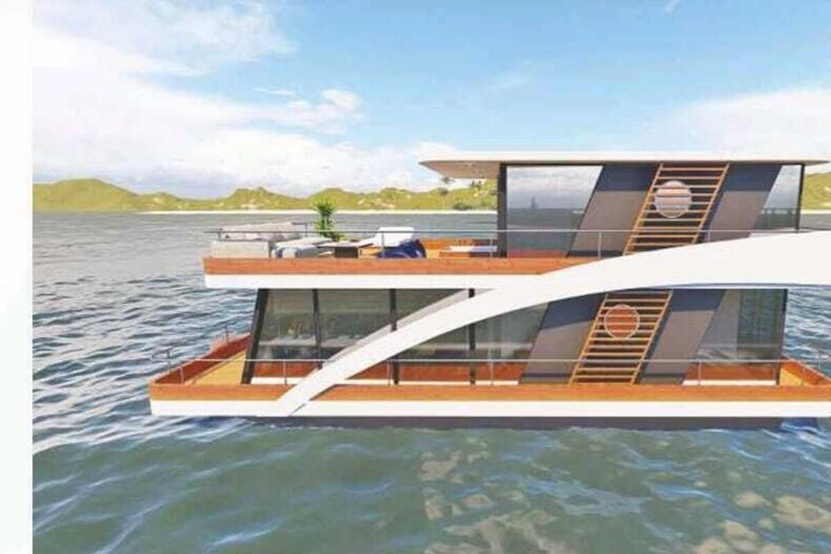 A modern floating house with a two-level structure, large glass windows, and a deck area.